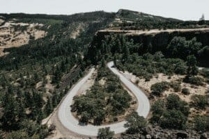 An aerial view of a winding road in the mountains.