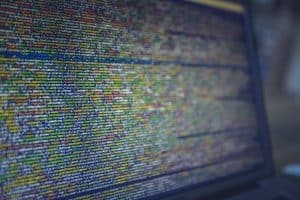 A close up of a laptop screen with code on it.