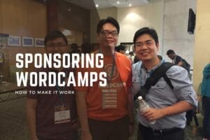 Three people stand together at a WordCamp event, one holding a water bottle, next to a sign that reads "Sponsoring WordCamps: How to Make It Work.